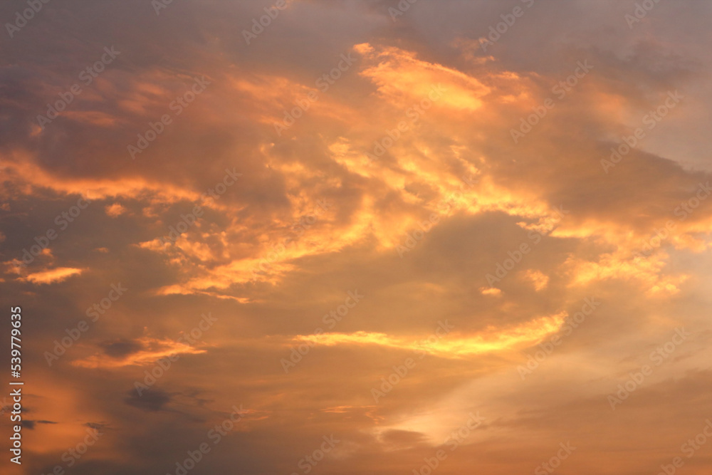 An image of a sky with yellow clouds at sunset for background and textures.