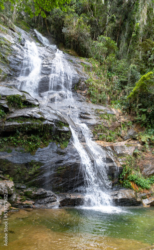 Big waterfall with small lake for bathing in rainforest inside Rio de Janeiro city, Brazil