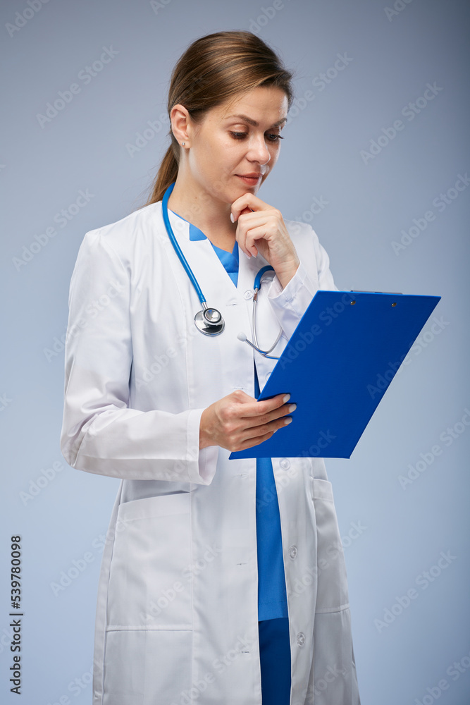 Woman doctor holding clipboard and reading medical history. isolated female portrait.