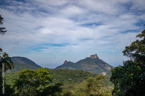View of the great rainforest, Atlantic Forest, inside the city of Rio de Janeiro, Pedra da Gavea Mountain Peak rock formation in the center, Brazil photo