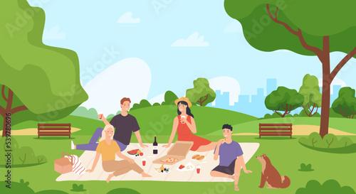 Summer picnic and recreation. Group of friends chilling and eating food in city park. Young man and woman sitting on blanket