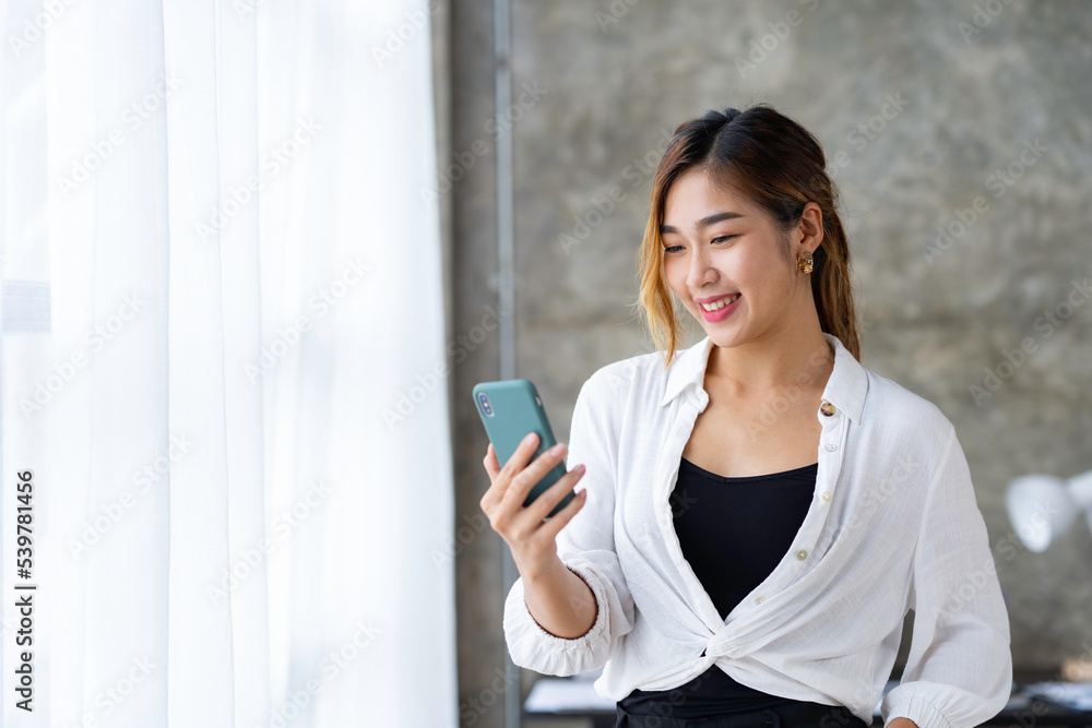 Beautiful and cute Asian business woman Office workers use their phones to take selfies on social media in the office. Beautiful and cute Asian business woman Office workers use their phones to take selfies on social media in the office.