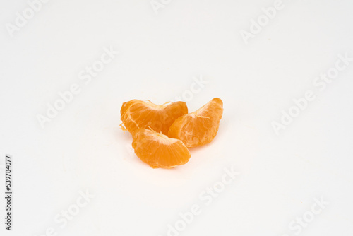 peeled tangerine slices on a white