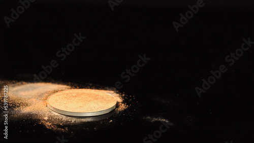 Face powder on black surface with copy space