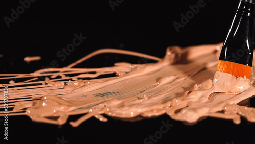 Close up view of cosmetic brush near face foundation on black background