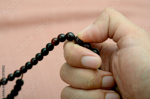 hands holding tasbih photo