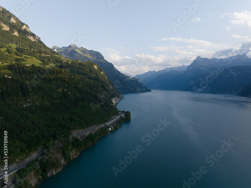 Vierwaldstattersee, Schwyz, located in Inner Switzerland, Aerial drone view of alpine lake road forrest and mountains. Turqoise water and environment overview.