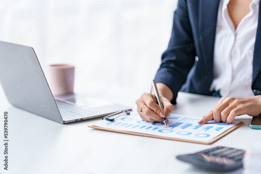Close-up of businesswoman hands working and pointing to a chart expenses, manage budget, income tax, budget, documents, credit documents, invoices. Close-up of businesswoman hands working and pointing to a chart expenses, manage budget, income tax, budget, documents, credit documents, invoices.
