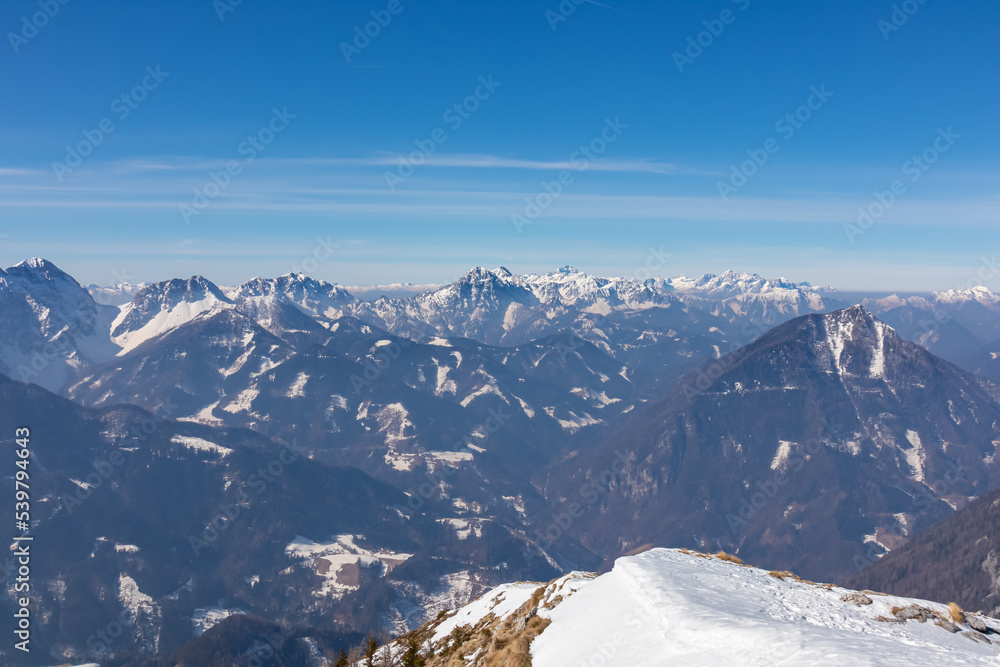 Snow shoe tracks leading to mountain near Zell Pfarre, Austrian Alps, Carinthia (Kaernten), Austria, Europe. Winter wonderland in Karawanks, Julian Alps. View from Freiberg on Hochstuhl, Stol, Triglav