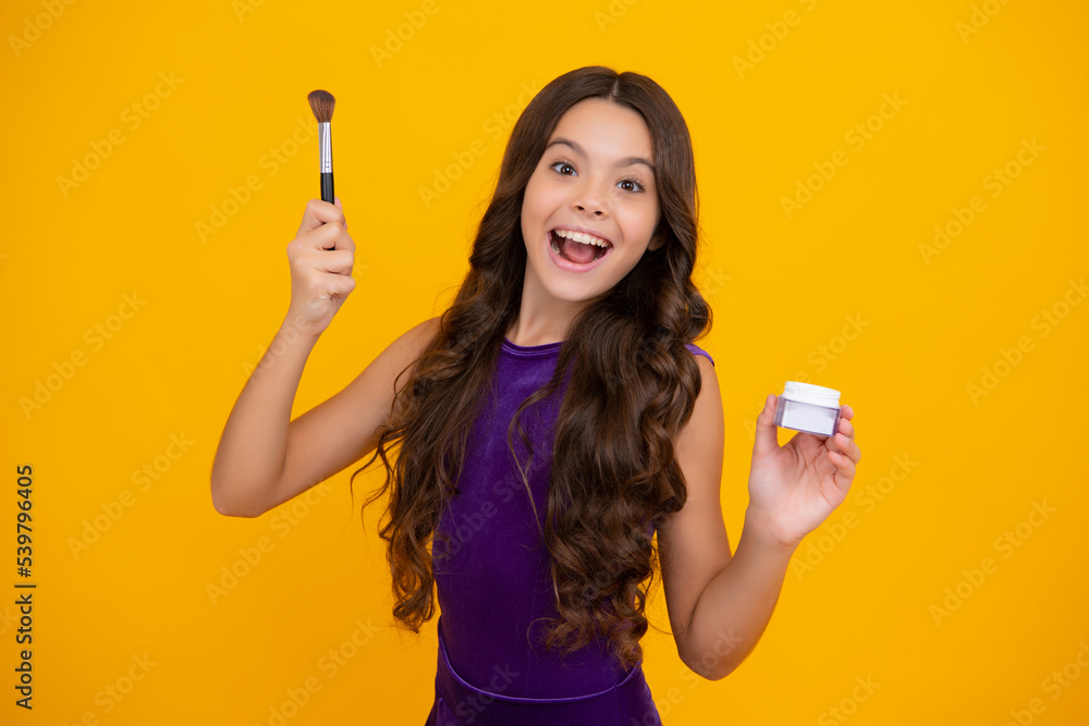 Beautiful portrait of teen girl child artist apply powder with make up brush. Makeup products. Beauty, and cosmetics for teenagers. Excited face, cheerful emotions of teenager girl. Beautiful portrait of teen girl child artist apply powder with make up brush. Makeup products. Beauty, and cosmetics for teenagers. Excited face, cheerful emotions of teenager girl.
