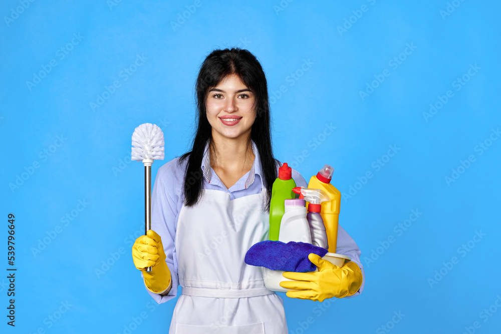 woman in gloves holding bucket of detergents woman in gloves holding bucket of detergents