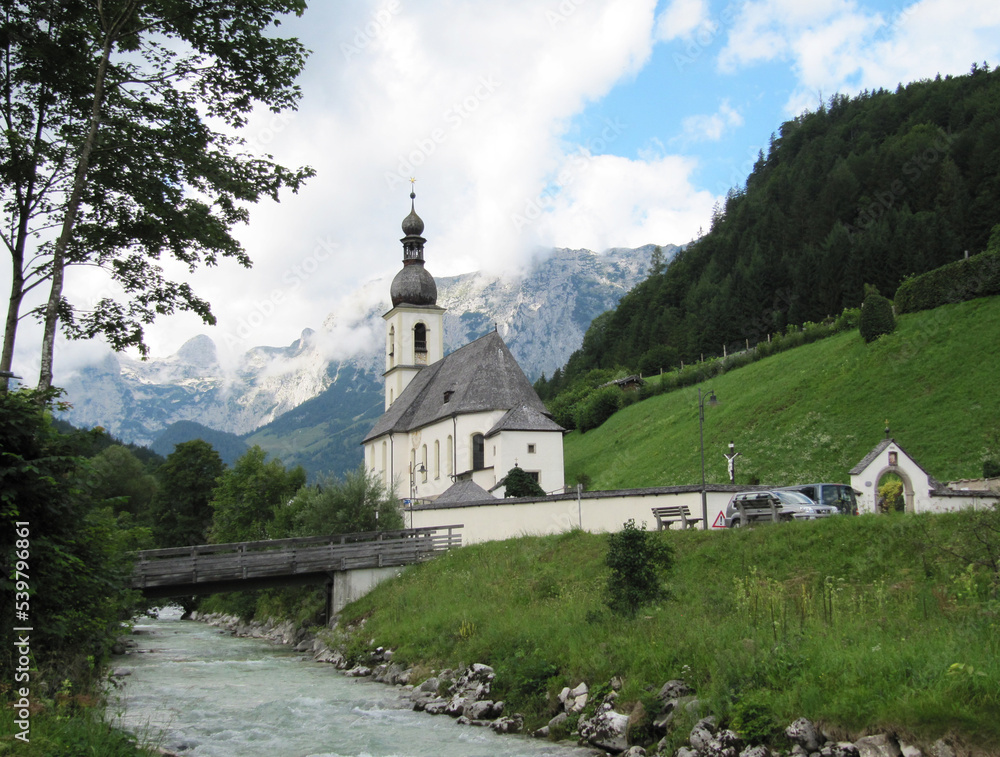Cute white church and stream in Ramsau, Berchtesgaden, Bavaria, Germany