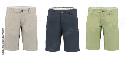 Collection of men's Bermuda shorts on a white background. Isolated image on a green background. Nobody. 