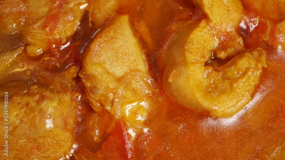 cooking chicken curry in a cooking pan cooking chicken curry in a cooking pan