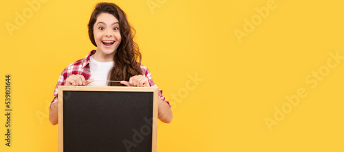 surprised child hold school blackboard for copy space, announcement. Banner of schoolgirl student. School child pupil portrait with copy space.
