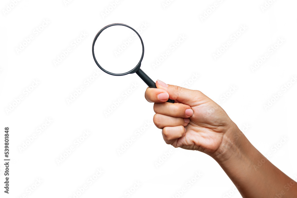 A female hand holding a magnifying glass isolated on a white background. Mockup with empty copy space for a text and design A female hand holding a magnifying glass isolated on a white background. Mockup with empty copy space for a text and design