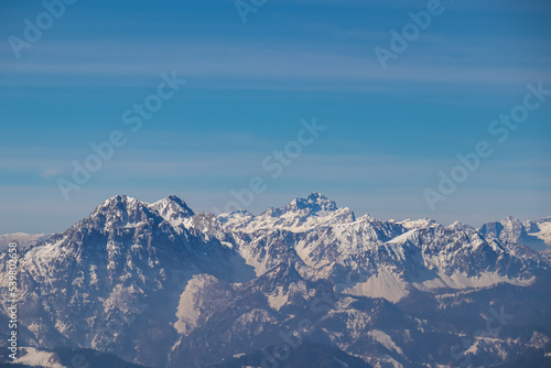 Scenic view on snow capped mountain peaks of Karawanks in Carinthia (Kaernten), Austria. Julian Alps. Winter wonderland in Austrian Alps, Europe. View from Freiberg on Hochstuhl (Stol), Triglav, Kepa