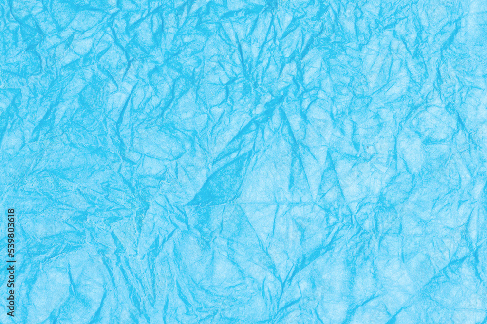 Crumpled paper abstract background texture. Blue color. Full frame