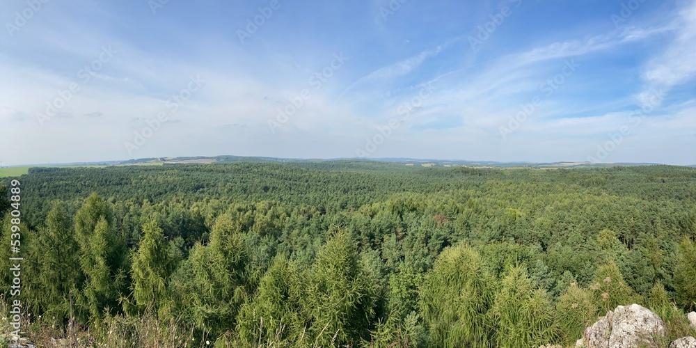 Obraz premium Summer day blue sky mountains landscape. Nature landscape with sun and blue sky. Summer travel in Europe mountains. Nature, lake, forest, trees hiking path. Clouds on blue sky. Forest landscape hiking