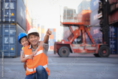 Asian father who owns an import-export, warehouse business. looking and pointing at containers and introducing and educate her knowledge for a daughter who wants to learning.family business succession