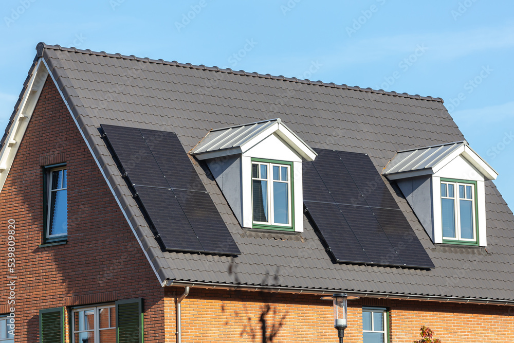 Solar panels installed on the tiled roof of a new house