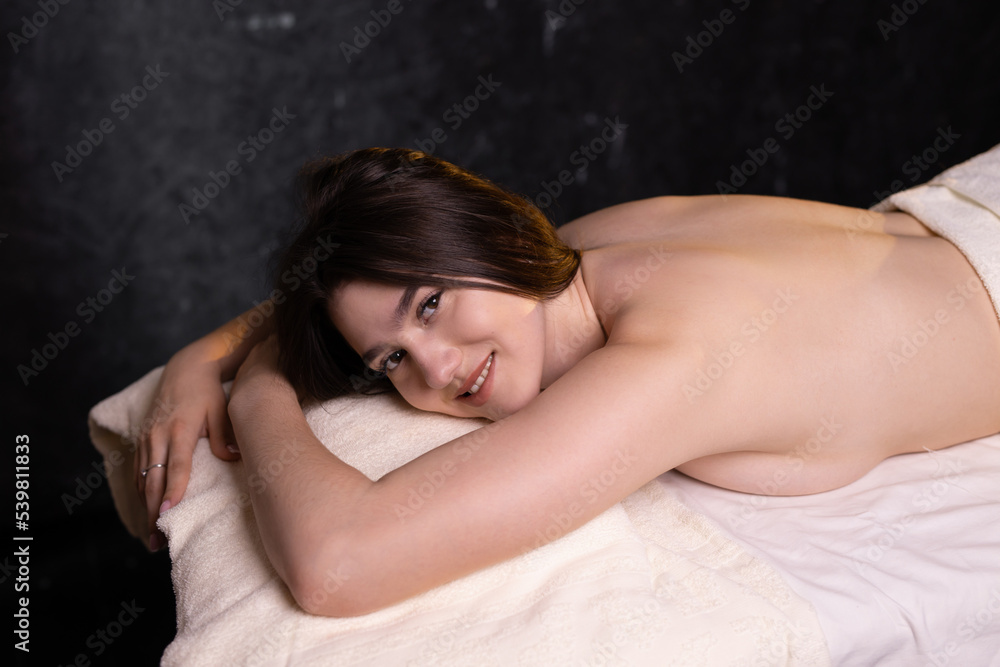 portrait of a beautiful young woman on a massage table	