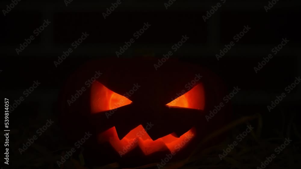 Halloween pumpkin with flickering eyes in darkness
Halloween pumpkin with flickering eyes in darkness