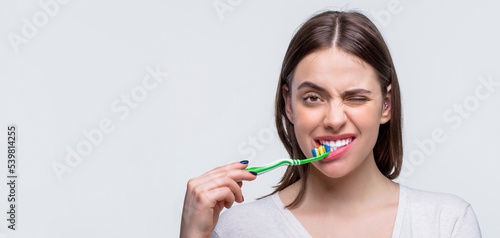 Wallpaper Mural Smiling woman with healthy beautiful teeth holding a toothbrush. Dental health background. Portrait of a smiling cute woman holding toothbrush Torontodigital.ca