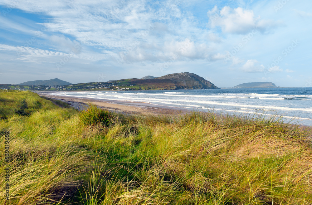 Pollan Bay, Donegal, Ireland. Two mile long sand beach strand and dunes near village of Ballyliffin in northwest Inishowen peninsula. Summer Pollan Bay, Donegal, Ireland. Two mile long sand beach strand and dunes near village of Ballyliffin in northwest Inishowen peninsula. Summer