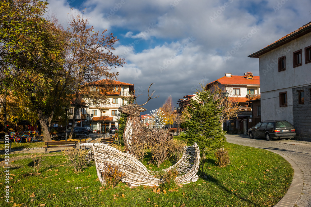 Cozy tiny square on the Gotse Delchev street in Bansko city center in the autumn sunny day.