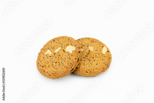 closeup of two brown cookies with white peanut or nut put overlapping, fresh homemade round bakery. danish christmas cookie isolated on white background, clipping path top view
