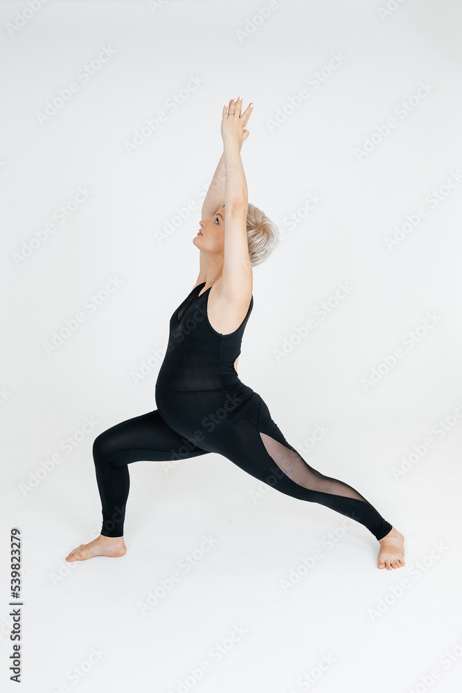 A 39 year old woman practices yoga at 36 weeks pregnant. Motherhood,yoga concept