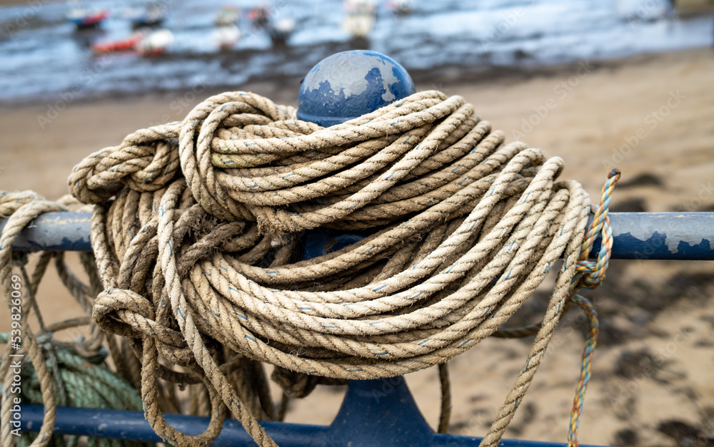 Ropes on a metal post on the quayside of Staithes harbour on the North Yorkshire coast