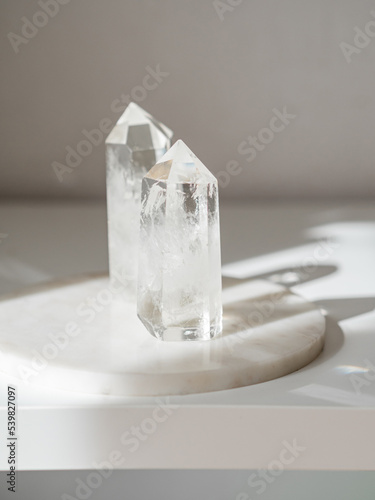 Collection of crystals quartz on a white background with shadows from sunlight.