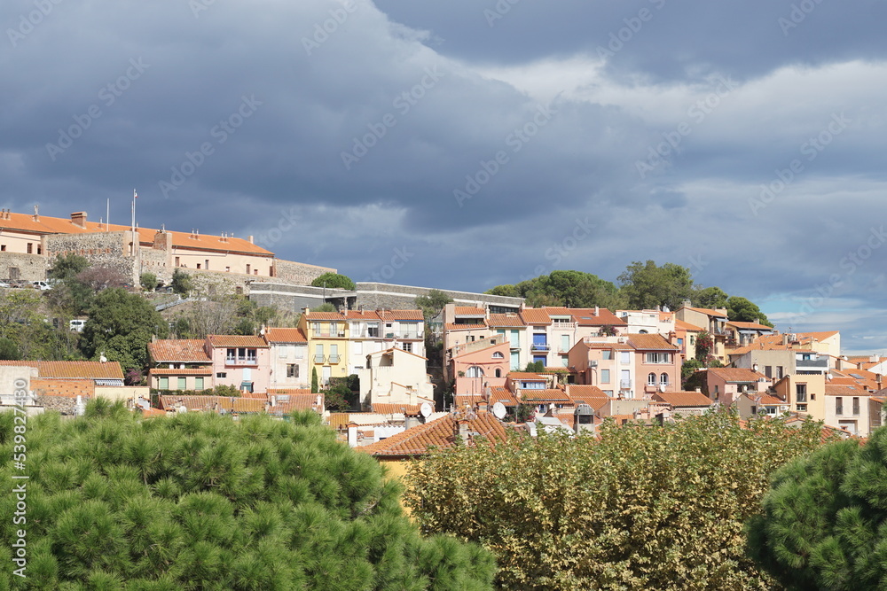 View of houses in Collioure, France against backdrop of overcast skies