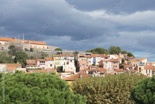 View of houses in Collioure, France against backdrop of overcast skies