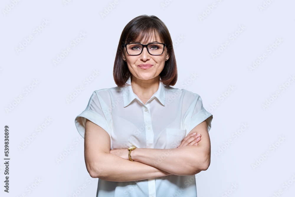 Attractive middle aged woman looking at camera on white background Attractive middle aged woman looking at camera on white background