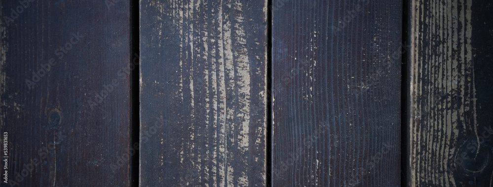 Rectangular background made of wooden boards. The shape of a banner with a dark wooden fence.