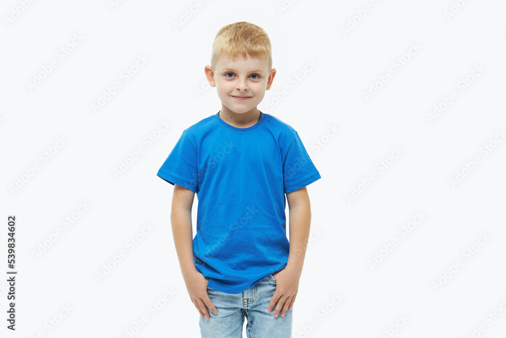 Stylish child boy model in a blue casual t-shirt on a white isolated background Stylish child boy model in a blue casual t-shirt on a white isolated background