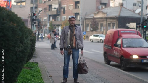 Wallpaper Mural Man standing with a travel bag in the city timelpase Torontodigital.ca