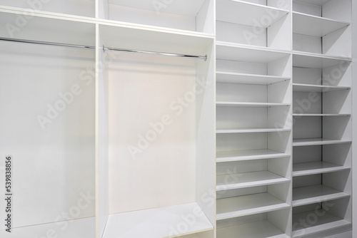 Open wardrobe with shelves in the room