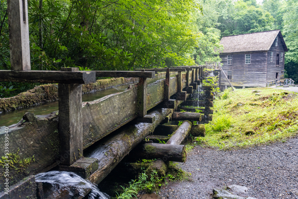 Mingus Mill at Great Smoky Mountains National Park. Water flows down a millrace to the mill. Historic gristmill was used for corn meal milling.