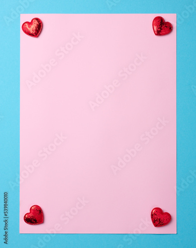 Empty pink paper sheet on blue background