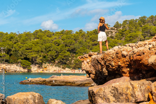 Vacation concept, A young woman at Salada y Saladeta beach enjoying the coast. Balearic photo