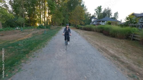 Wallpaper Mural Adventure Woman bike riding on a bicycle trail surrounded by green trees. Summer Sunset. Pitt Meadows, Greater Vancouver, British Columbia, Canada. Torontodigital.ca