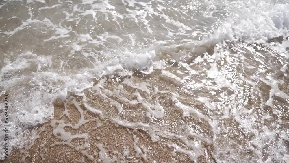 Beautiful sea waves on a summer sunny day on the sandy beach. Close-up, no people. Super slow motion. Beautiful sea waves on a summer sunny day on the sandy beach. Close-up, no people. Super slow motion.