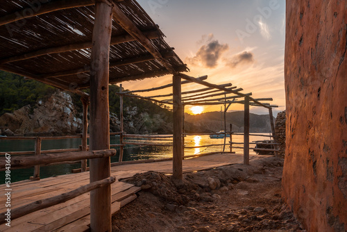 Wooden structure in the beach houses at sunset in Benirras in Ibiza. vacation concept © unai