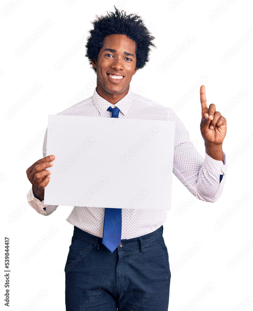 Handsome african american man with afro hair holding blank empty banner surprised with an idea or question pointing finger with happy face, number one Handsome african american man with afro hair holding blank empty banner surprised with an idea or question pointing finger with happy face, number one