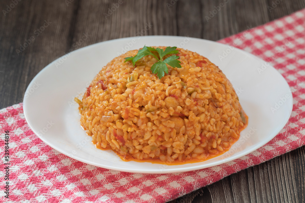 Traditional turkish bulgur pilaf with tomato sause in plate (Turkish name; meyhane pilavi) Traditional turkish bulgur pilaf with tomato sause in plate (Turkish name; meyhane pilavi)