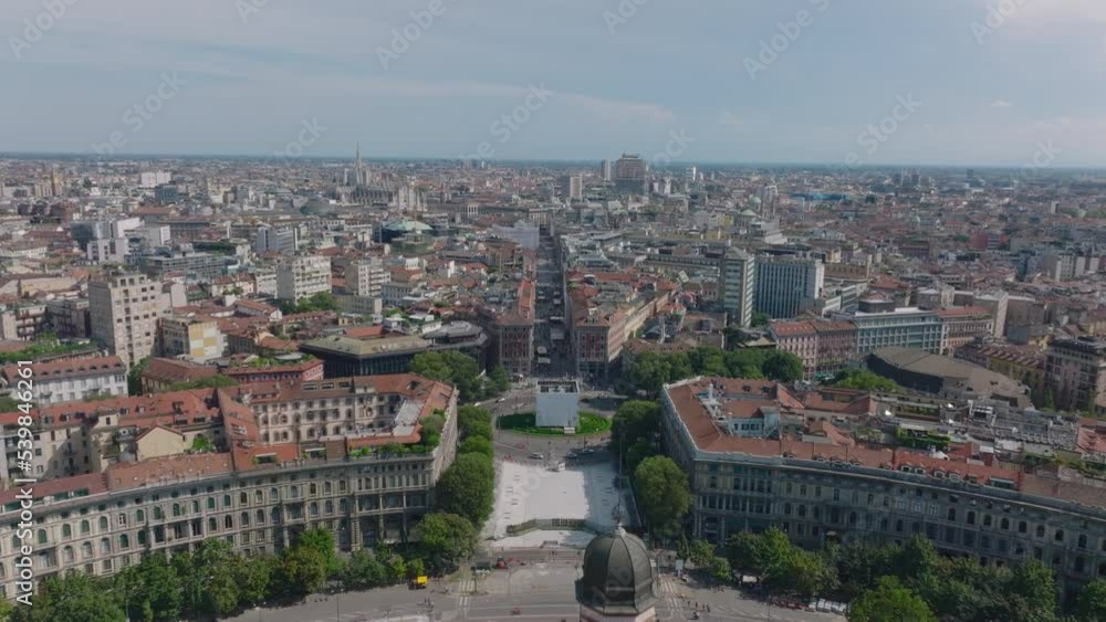 Fly over tower of medieval Castello Sforzesco and circular arrangement of buildings. Cityscape on sunny day. Milano, Italy Fly over tower of medieval Castello Sforzesco and circular arrangement of buildings. Cityscape on sunny day. Milano, Italy